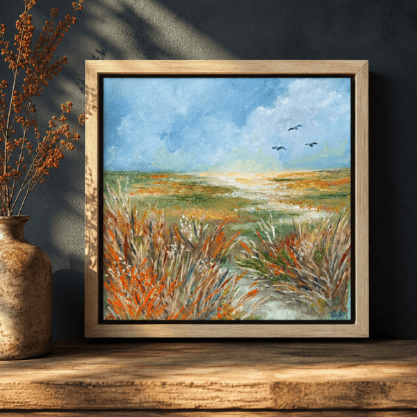 Framed 20 cm by 20 cm original oil painting of textured coastal wetlands, with warm grasses, distant water and four birds flying across a soft blue sky.