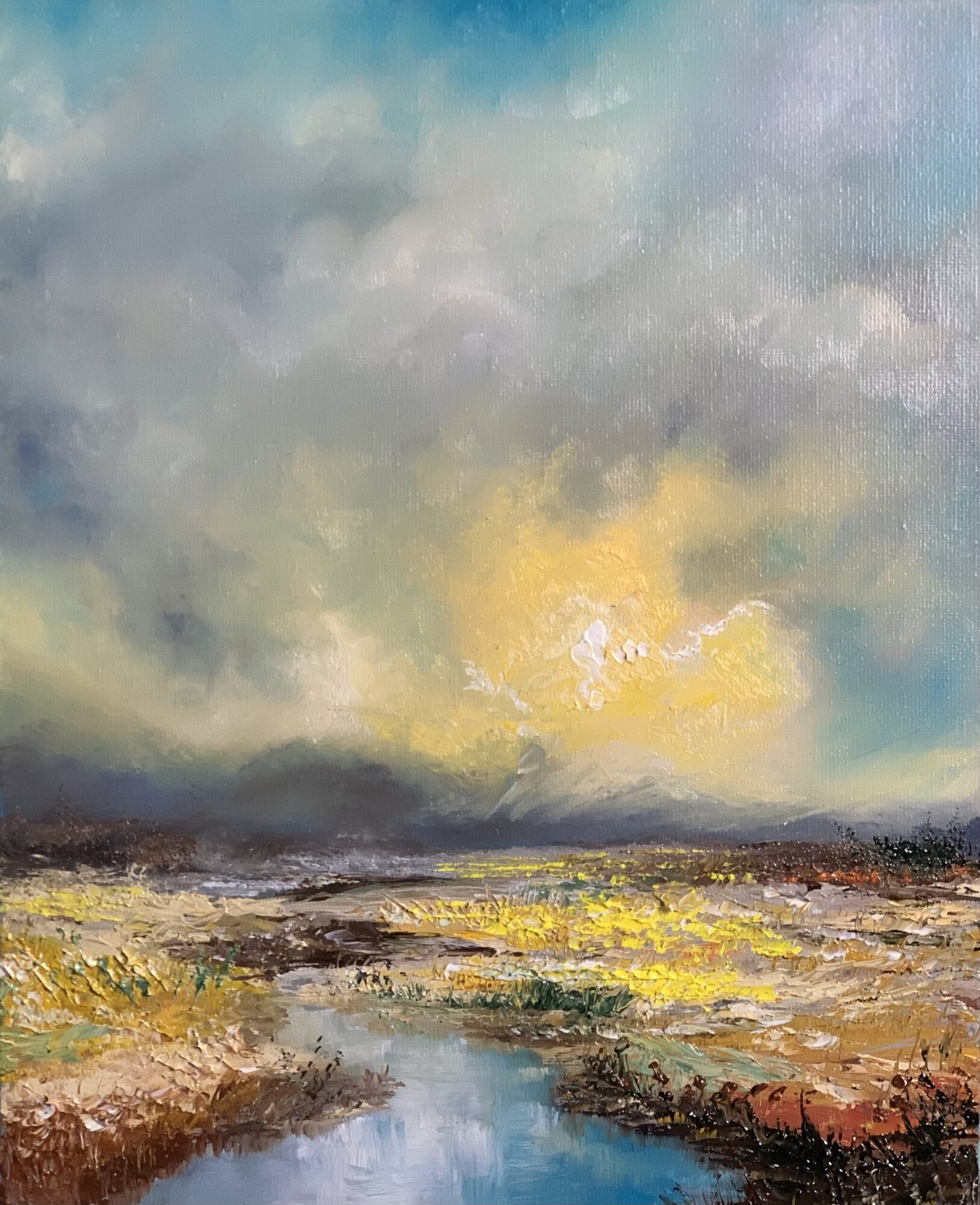 Original 30 × 40 cm palette knife oil landscape painting featuring dramatic storm clouds breaking to reveal golden sunlight over the French countryside. Thick impasto textures, a reflective stream, and expressive brushwork create a contemporary impressionist landscape full of atmosphere, movement, and light.