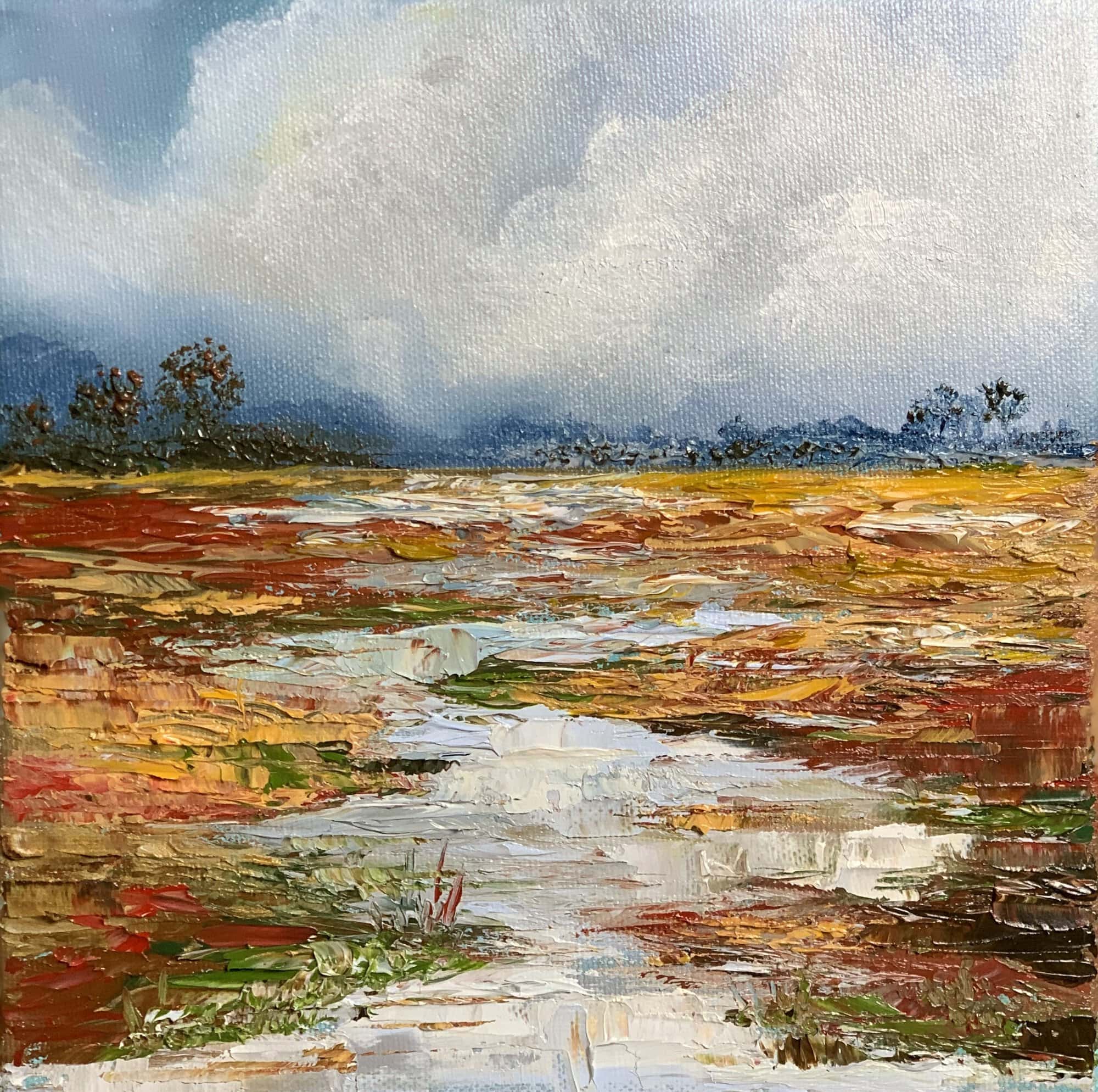 Framed 20 x 20 cm palette knife oil painting of a winding stream crossing textured autumn marshland beneath a dramatic blue and white cloudy sky.