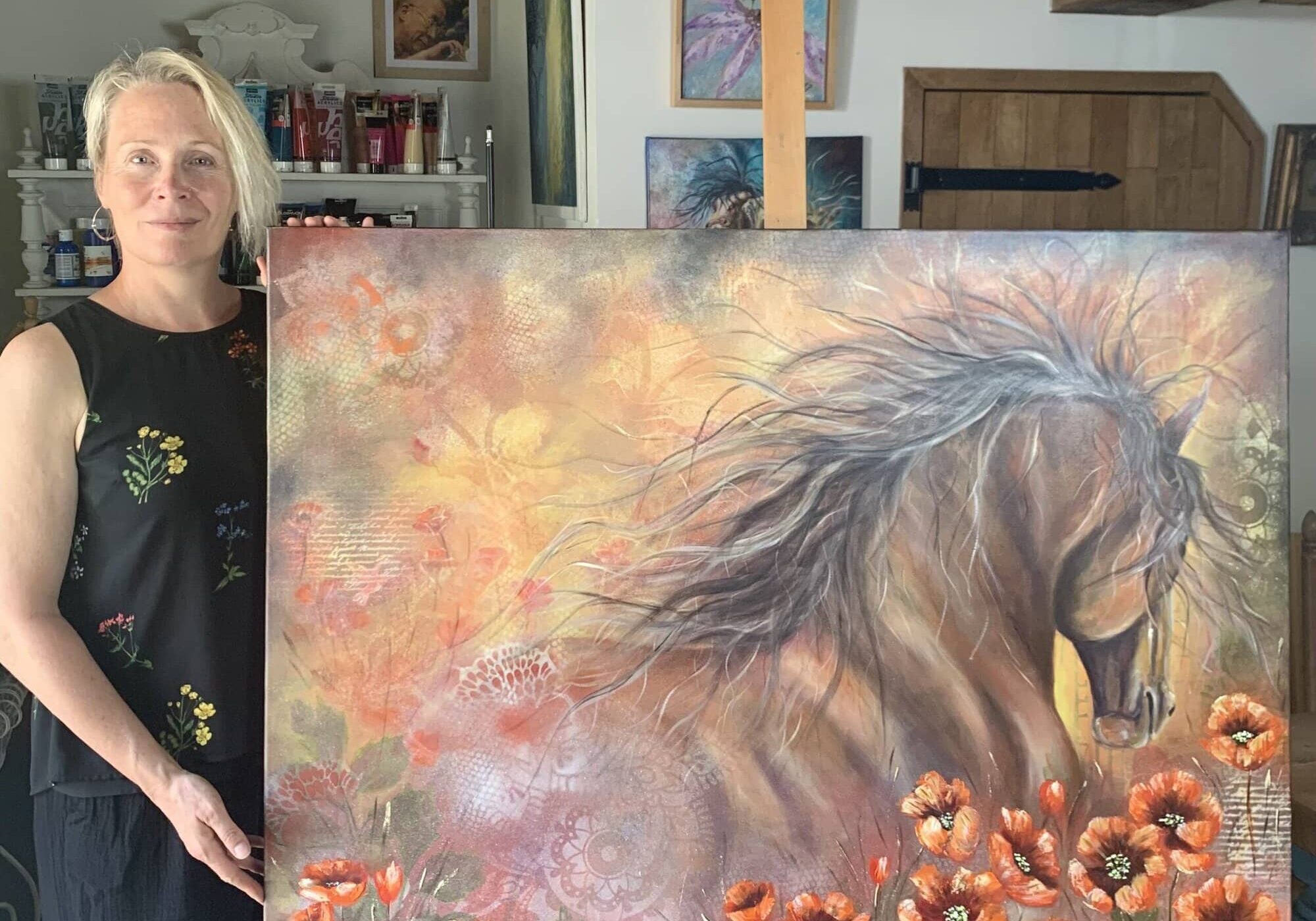 Studio photo of Tandy Pengelly Artist with War Horse painting